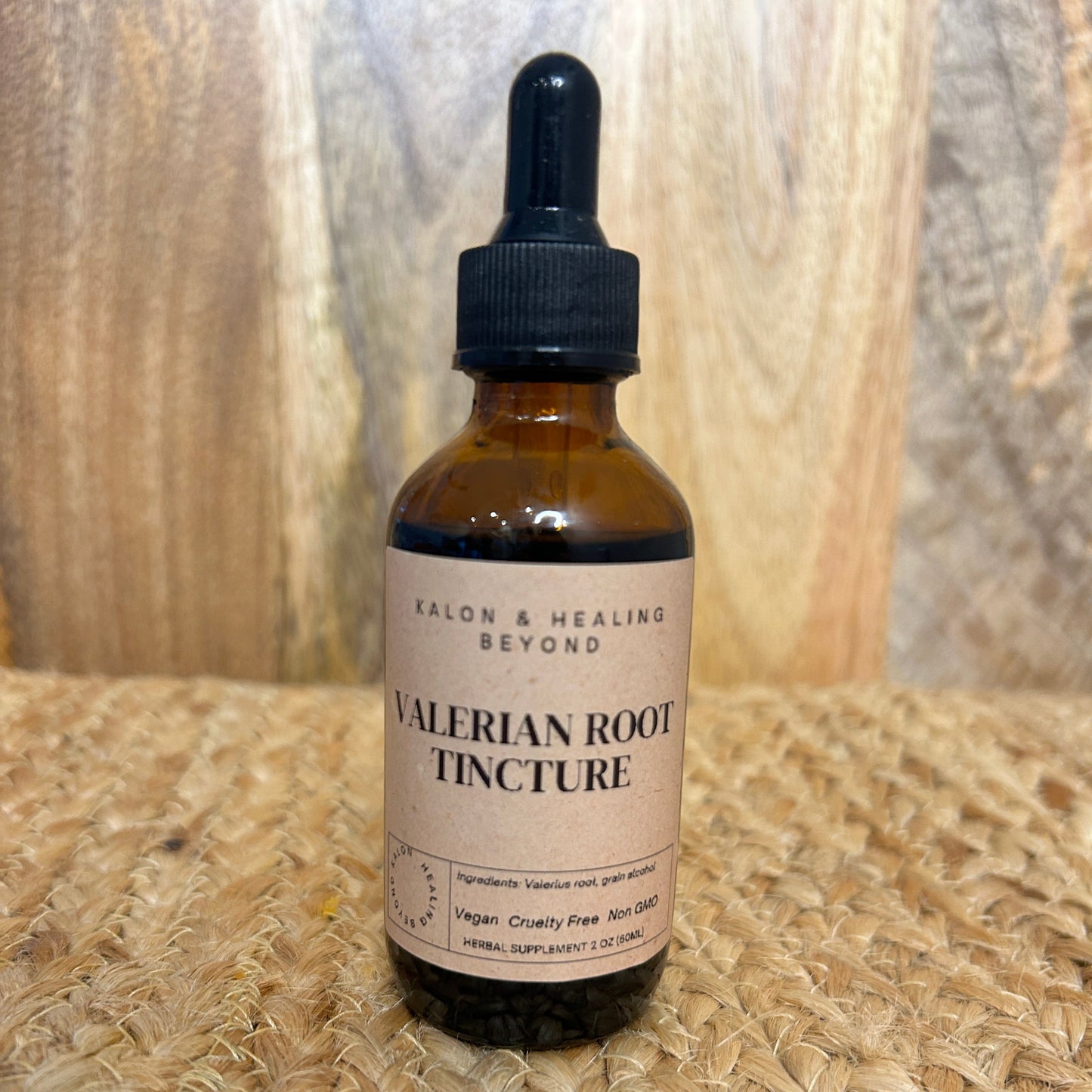 Bottle of Valerian Root Tincture on a wooden surface with a woven mat background