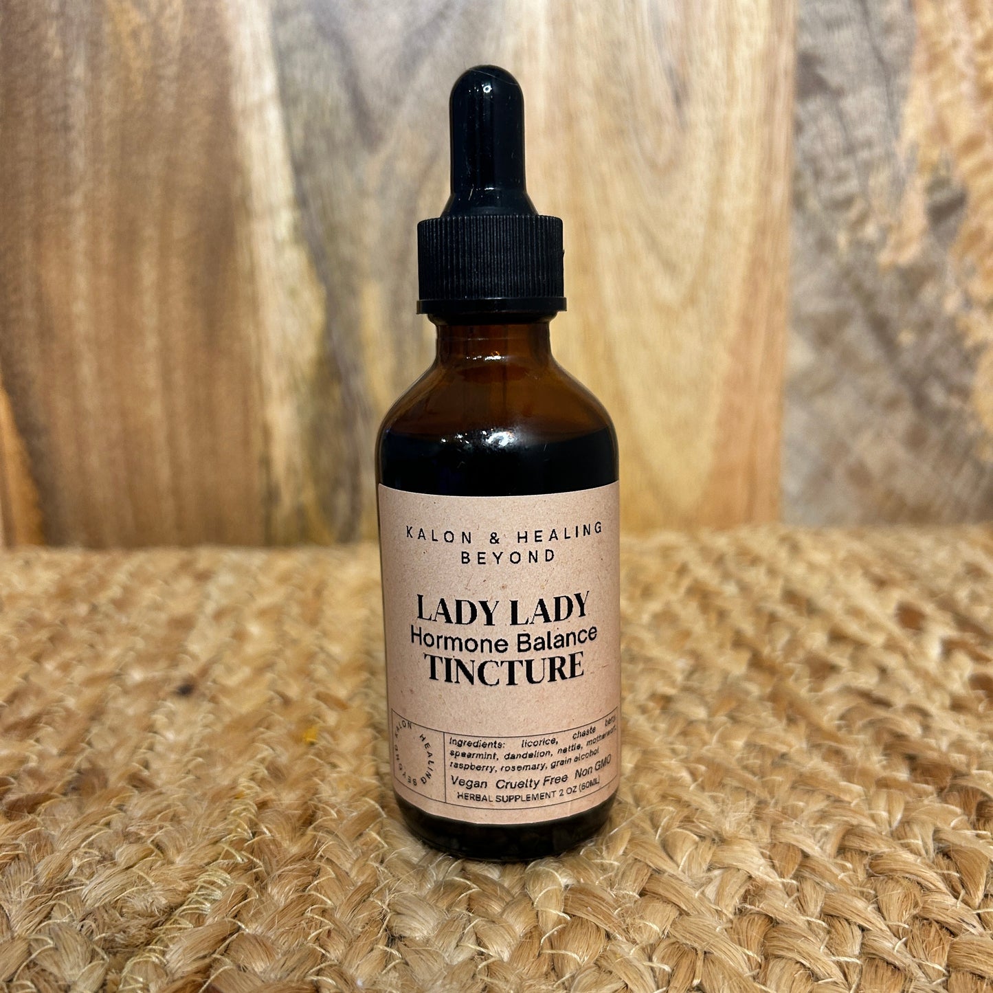 Bottle of Lady Lady Herbal Balance Tincture on a textured surface