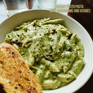 Creamy Pesto pasta with spiraled zucchini, (or noodles) mushrooms and veggies