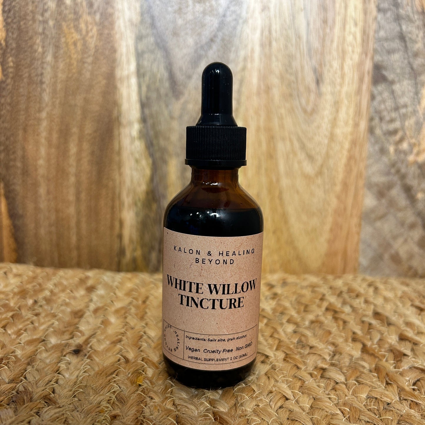 Bottle of White Willow Tincture on a wooden surface