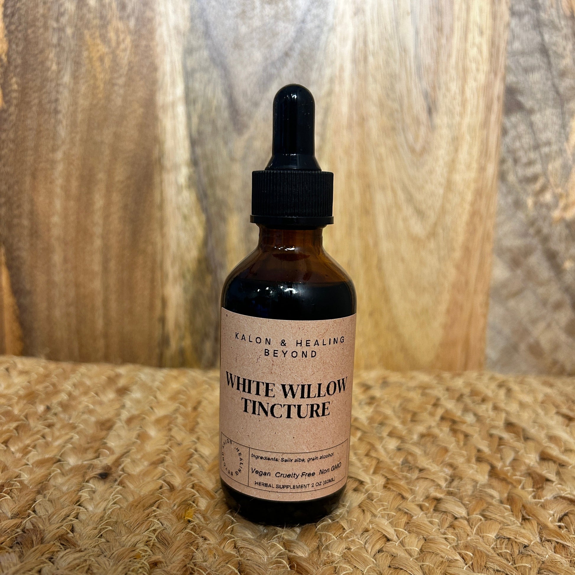Bottle of White Willow Tincture on a wooden surface